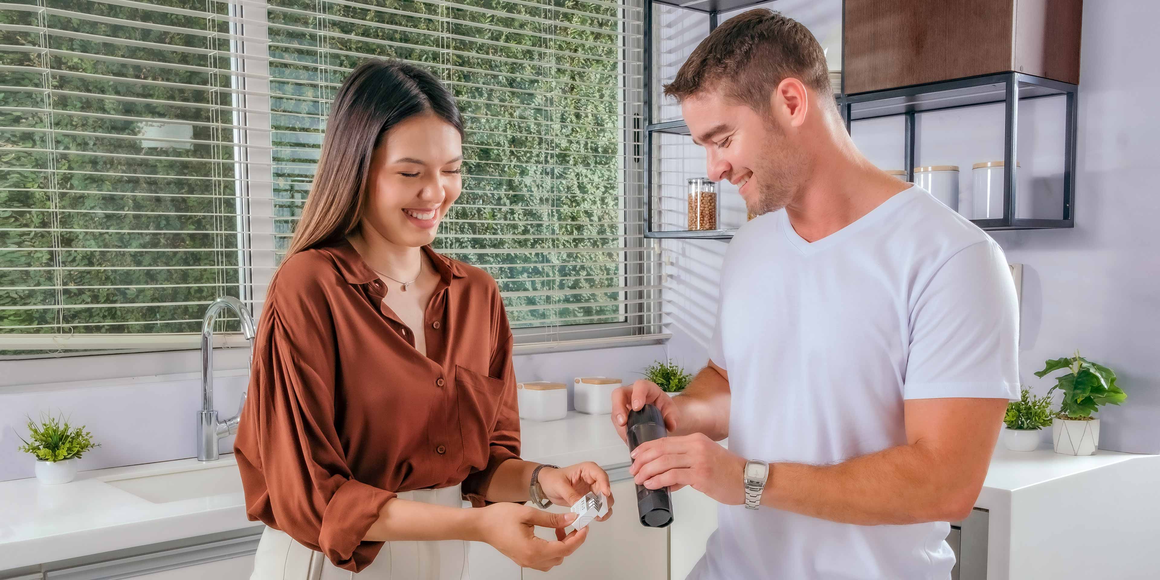 A couple laugh while filling some ArcPods with their Xtruder, in preparation for a date night.