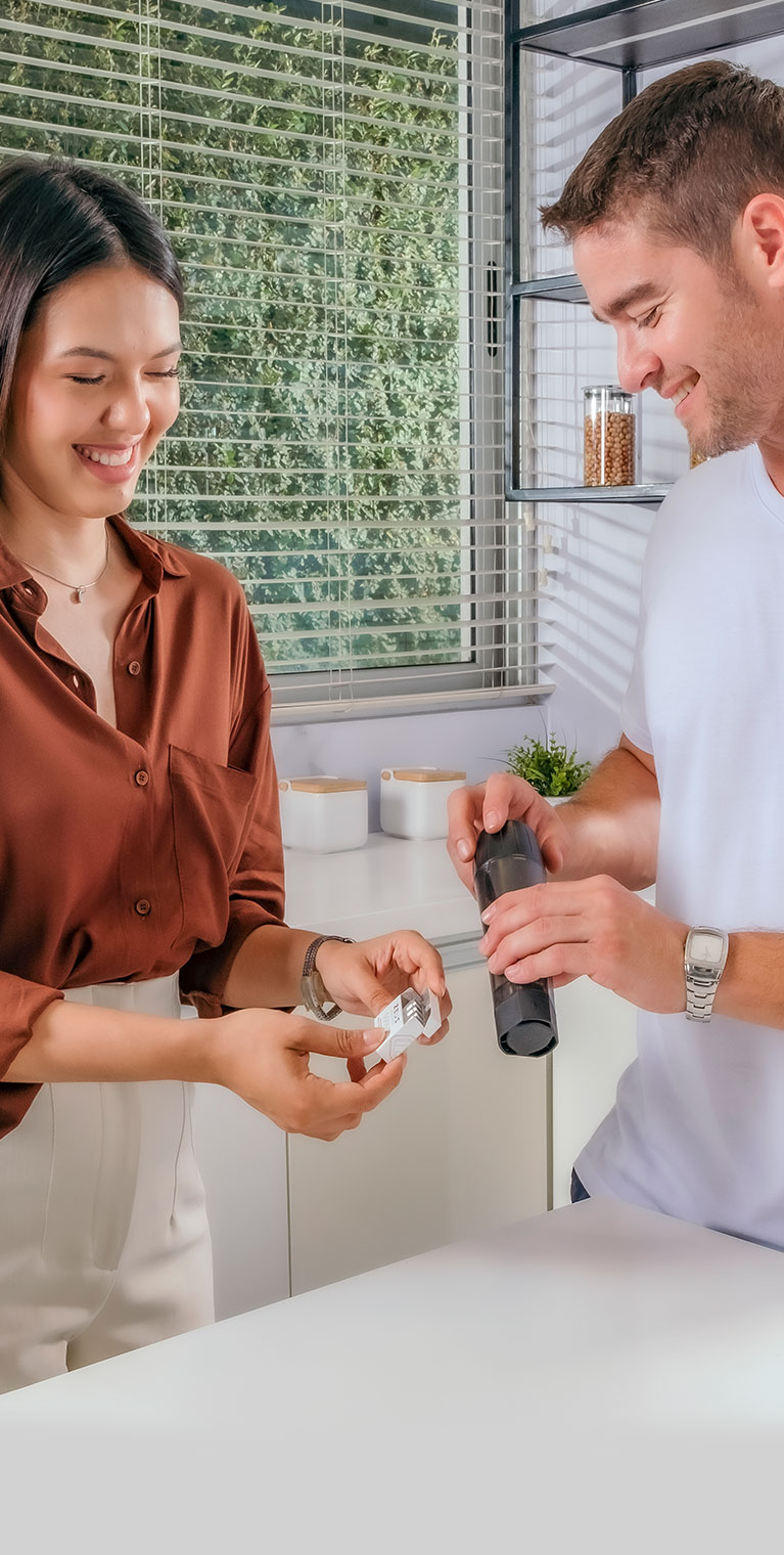 A couple laugh while filling some ArcPods with their Xtruder, in preparation for a date night.